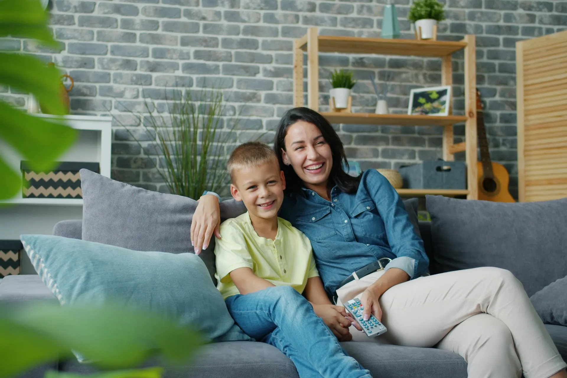 Mother and son laughing together on the couch